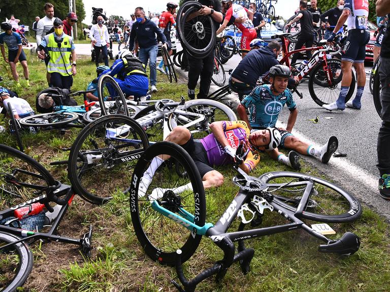 WATCH Spectator causes massive, terrifying crash at the Tour De France
